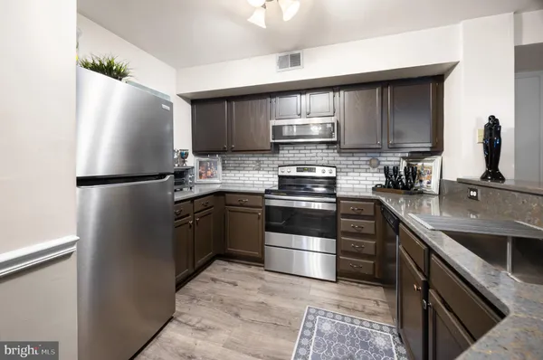 a kitchen with a sink appliances and cabinets