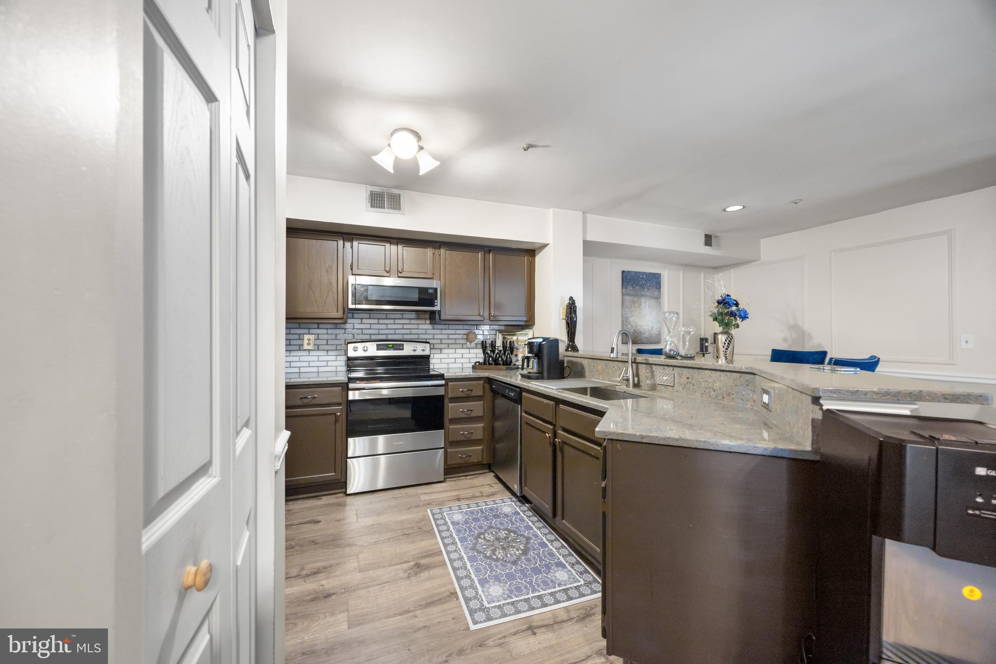 10 Sandstone Court Annapolis, MD 21403 - Photo 8 of 17 a kitchen with stainless steel appliances granite countertop a sink stove and refrigerator