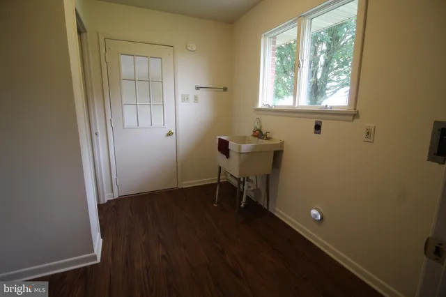 an empty room with wooden floor and furniture