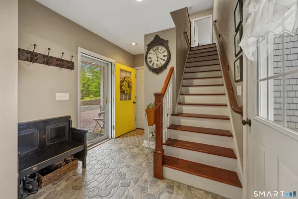 a view of entryway with furniture and wooden floor