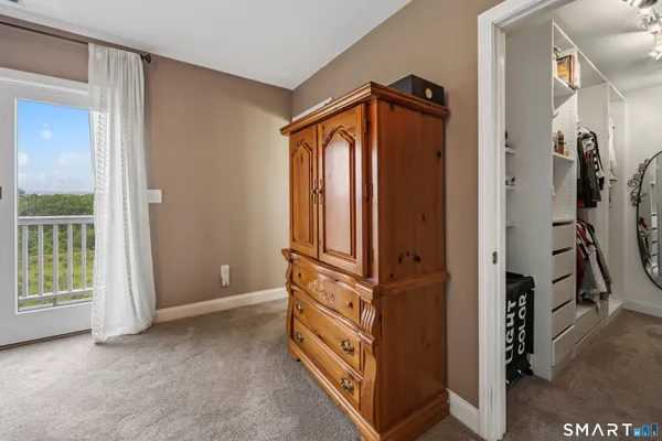 a view of walk in closet with clothes
