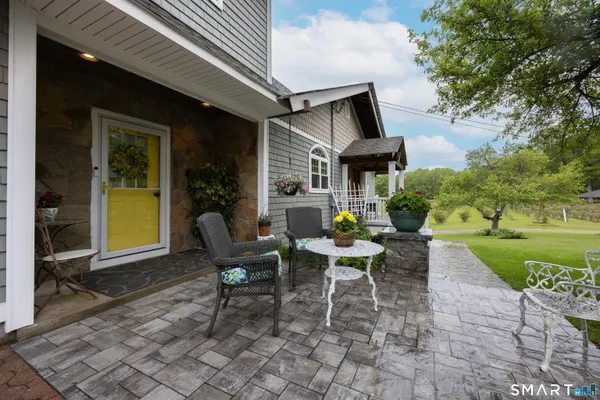 a view of a house with backyard sitting area and garden