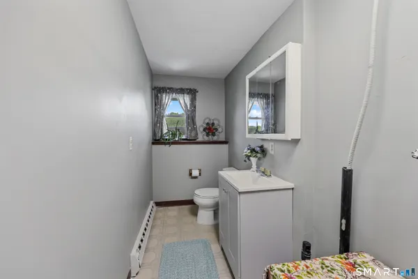 a bathroom with a sink toilet and mirror