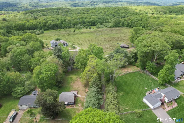 an aerial view of a house with a yard
