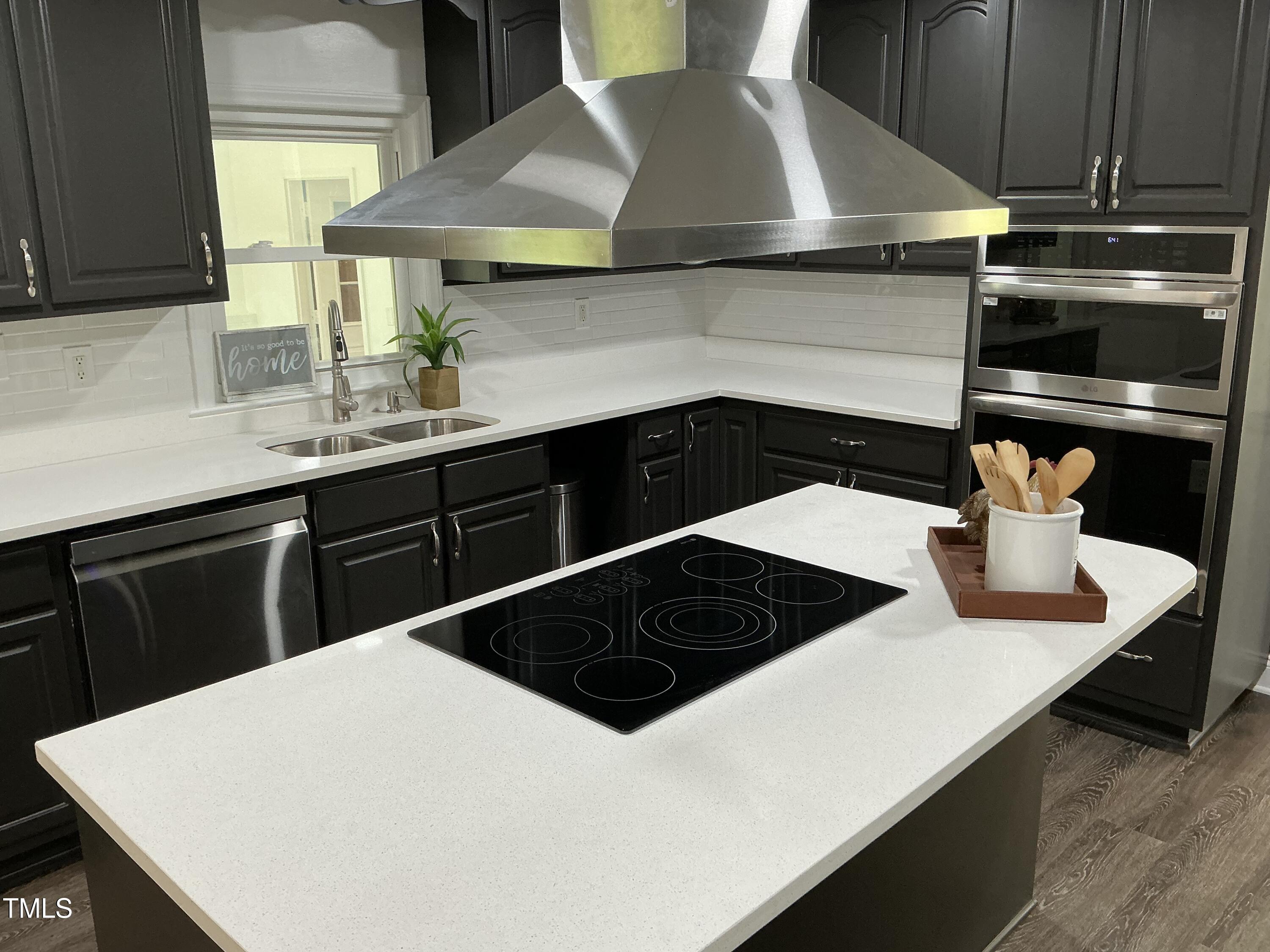 3417 Glenn Road Durham, NC 27704 - Photo 49 of 80 a kitchen with a sink a stove and cabinets