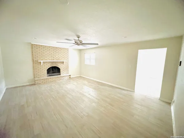 a view of an empty room with a fireplace