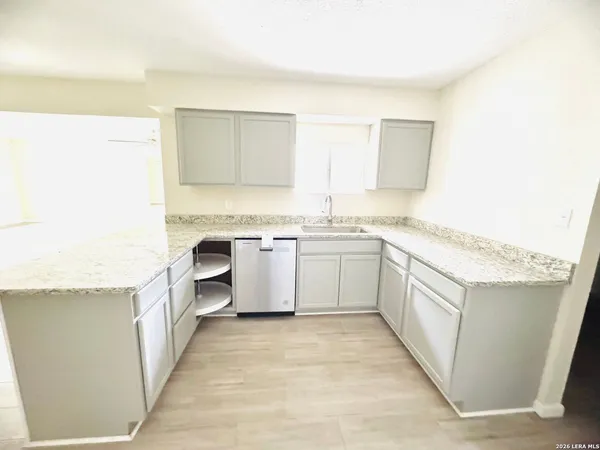 a view of a kitchen with white cabinets