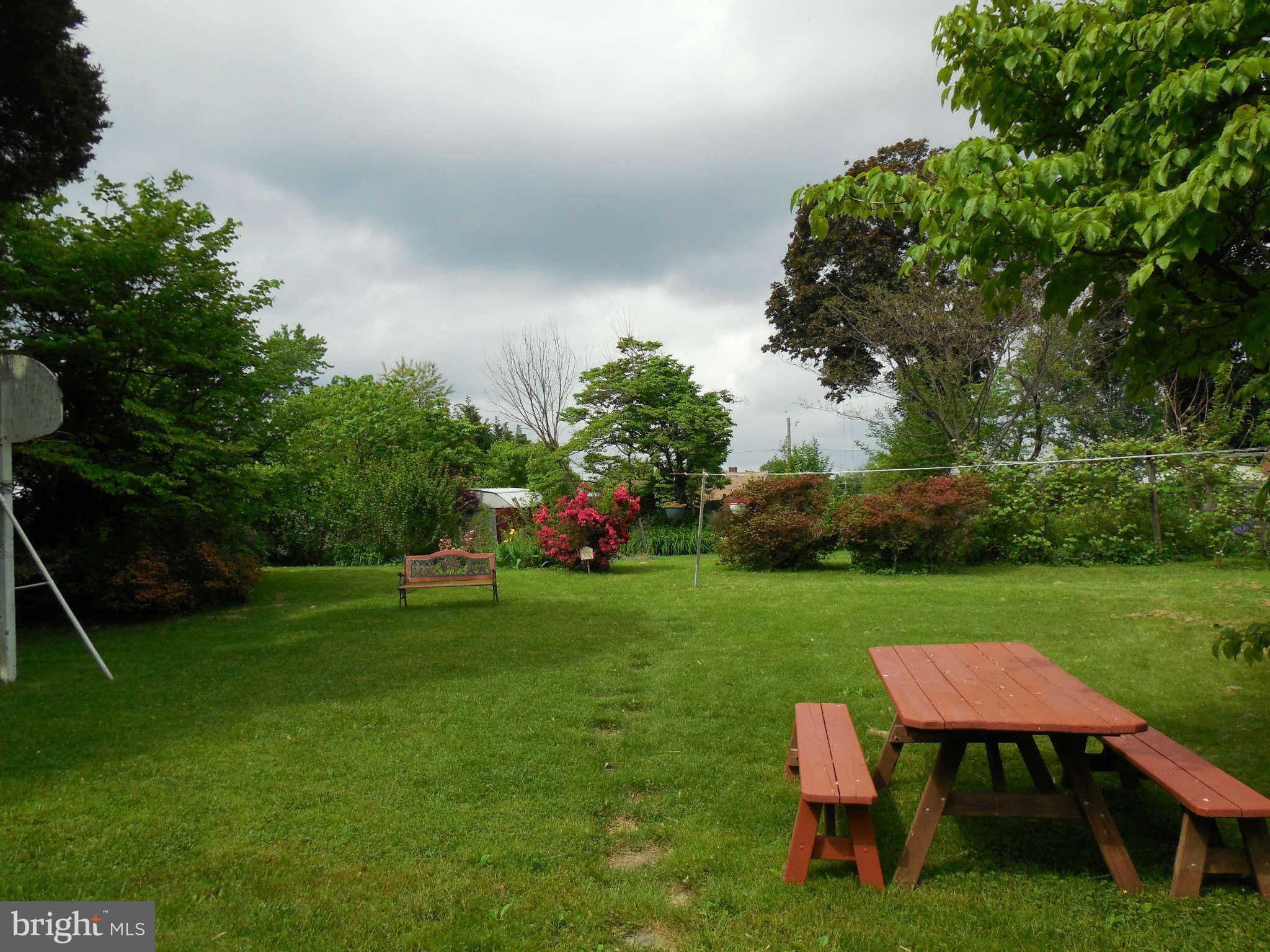 12703 Holdridge Road Silver Spring, MD 20906 - Photo 22 of 25 a backyard of a house with table and chairs