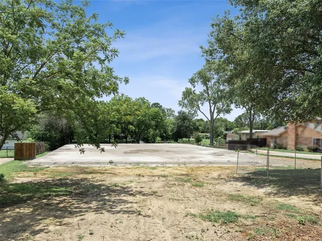 a view of a yard with snow on the road