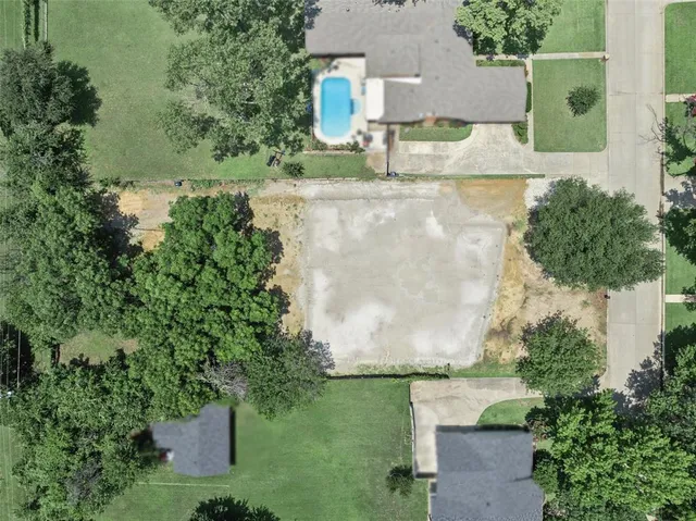 an aerial view of a house with yard