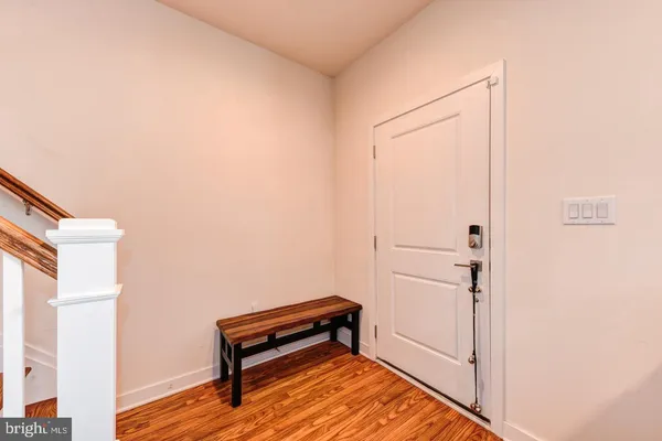 a room with a bench and a wooden floor