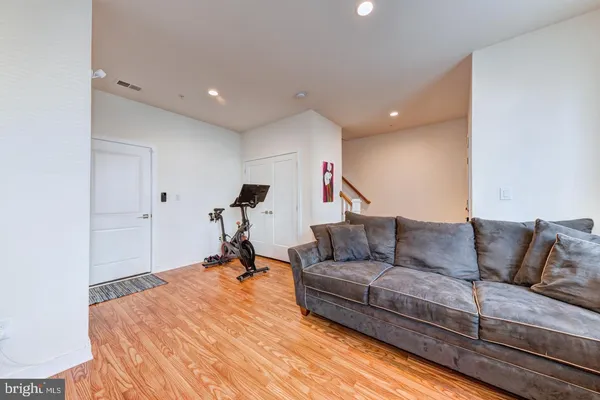 a living room with furniture and a wooden floor