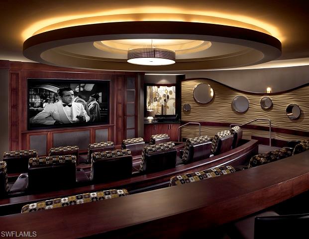 13665 Vanderbilt Drive, Unit 701 Naples, FL 34110 - Photo 12 of 22 a room with furniture and flat screen tv