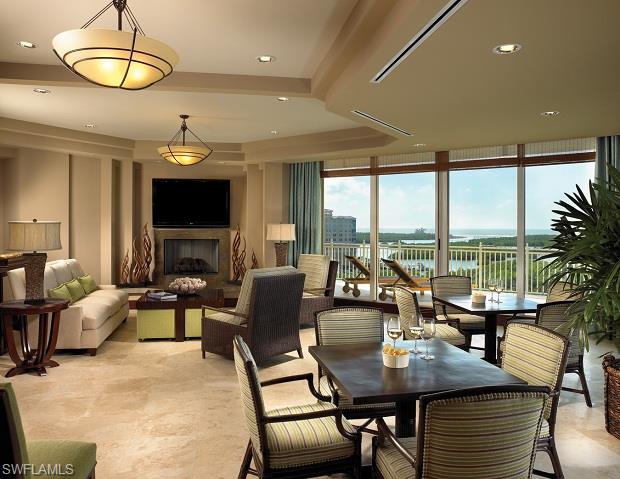 13665 Vanderbilt Drive, Unit 701 Naples, FL 34110 - Photo 16 of 22 a view of a dining room with furniture window and outside view