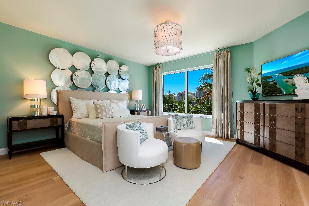 13665 Vanderbilt Drive, Unit 701 Naples, FL 34110 - Photo 4 of 22 a living room with furniture and a large window