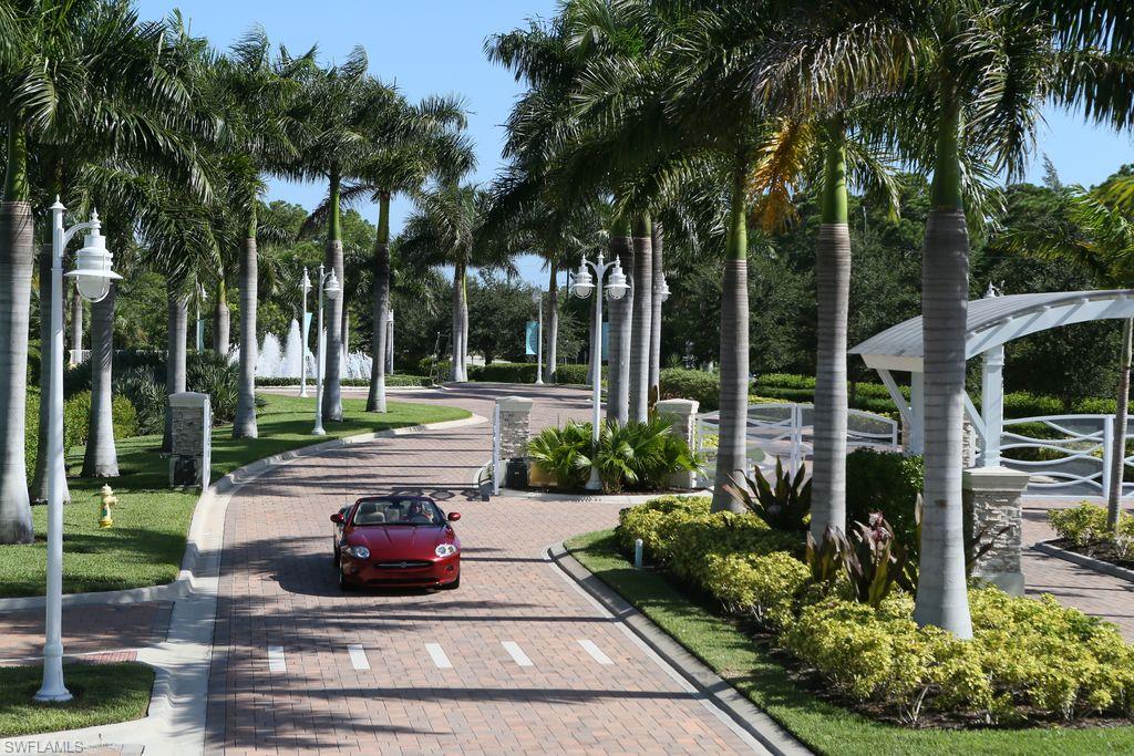 13665 Vanderbilt Drive, Unit 701 Naples, FL 34110 - Photo 9 of 22 a view of a garden with palm trees