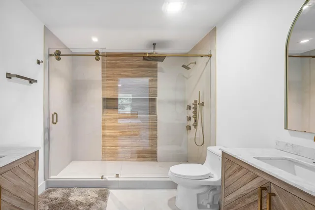 a bathroom with a sink a toilet and a mirror