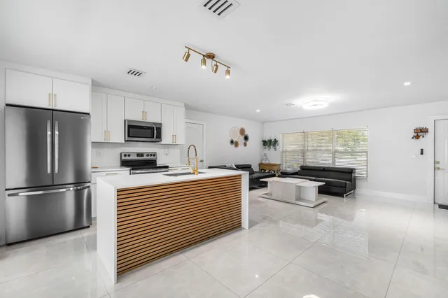 a kitchen with refrigerator and cabinets