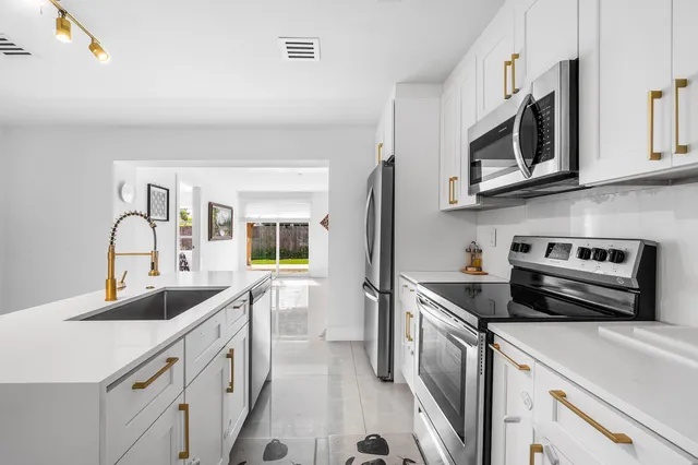 a living room with furniture and a painting on the wall