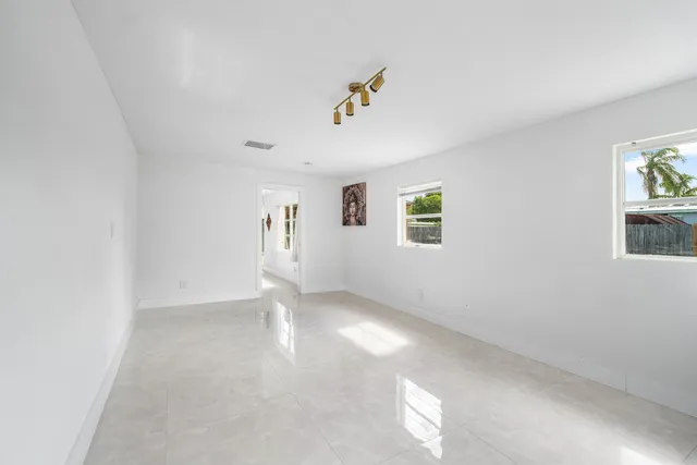 a view of a big room with windows and entryway