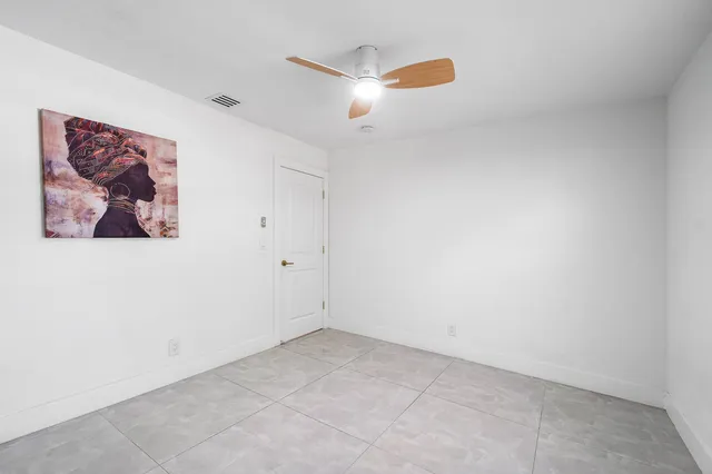 a bathroom with a granite countertop sink and a toilet