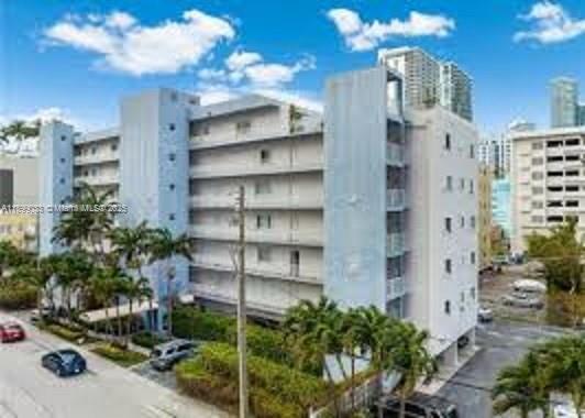 677 Northeast 24th Street, Unit 406 Miami, FL 33137 - Photo 1 of 15 a view of a house with a windows and plants