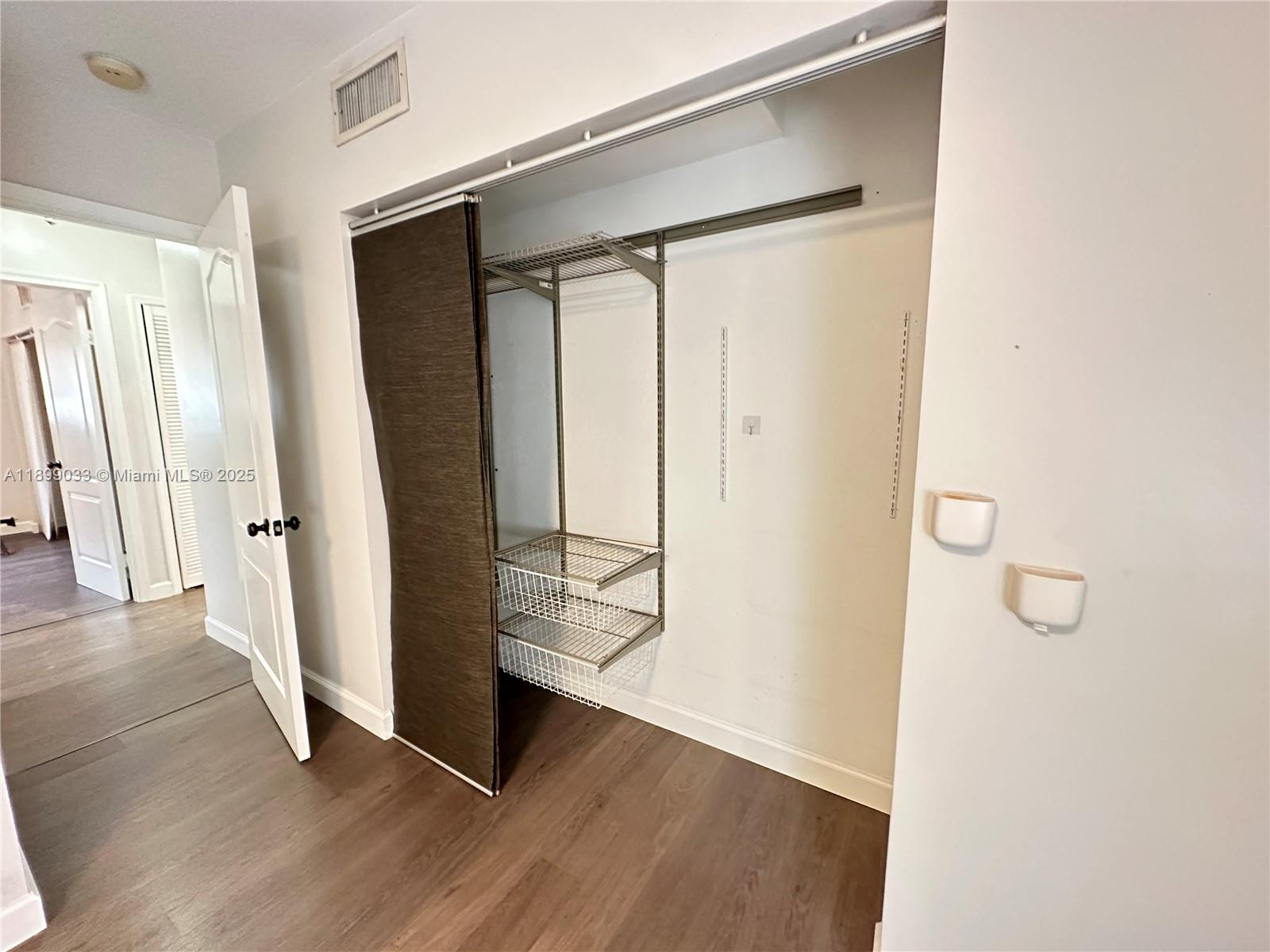 677 Northeast 24th Street, Unit 406 Miami, FL 33137 - Photo 12 of 15 a view of an entryway with wooden floor