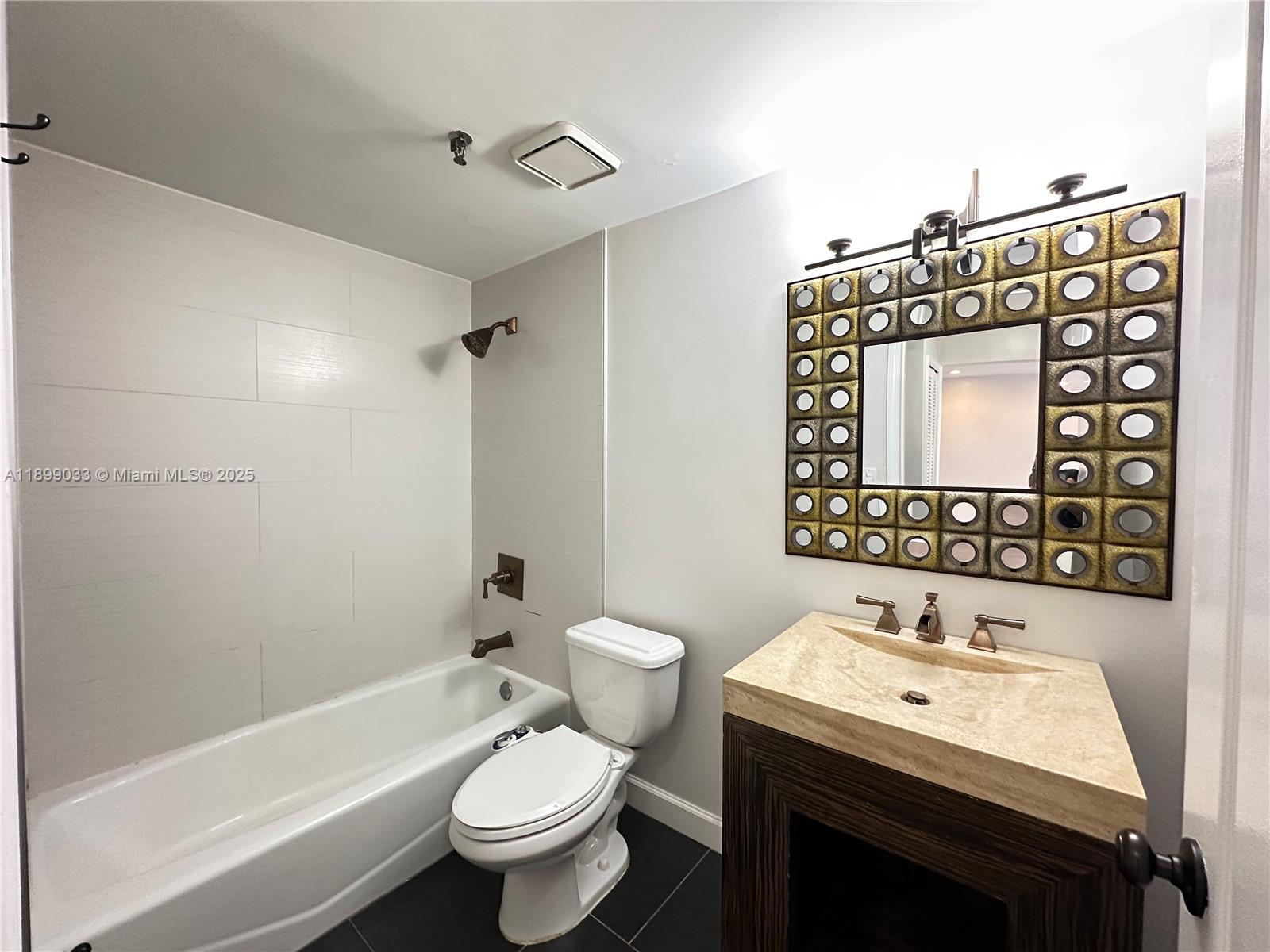 677 Northeast 24th Street, Unit 406 Miami, FL 33137 - Photo 13 of 15 a bathroom with a sink toilet and shower