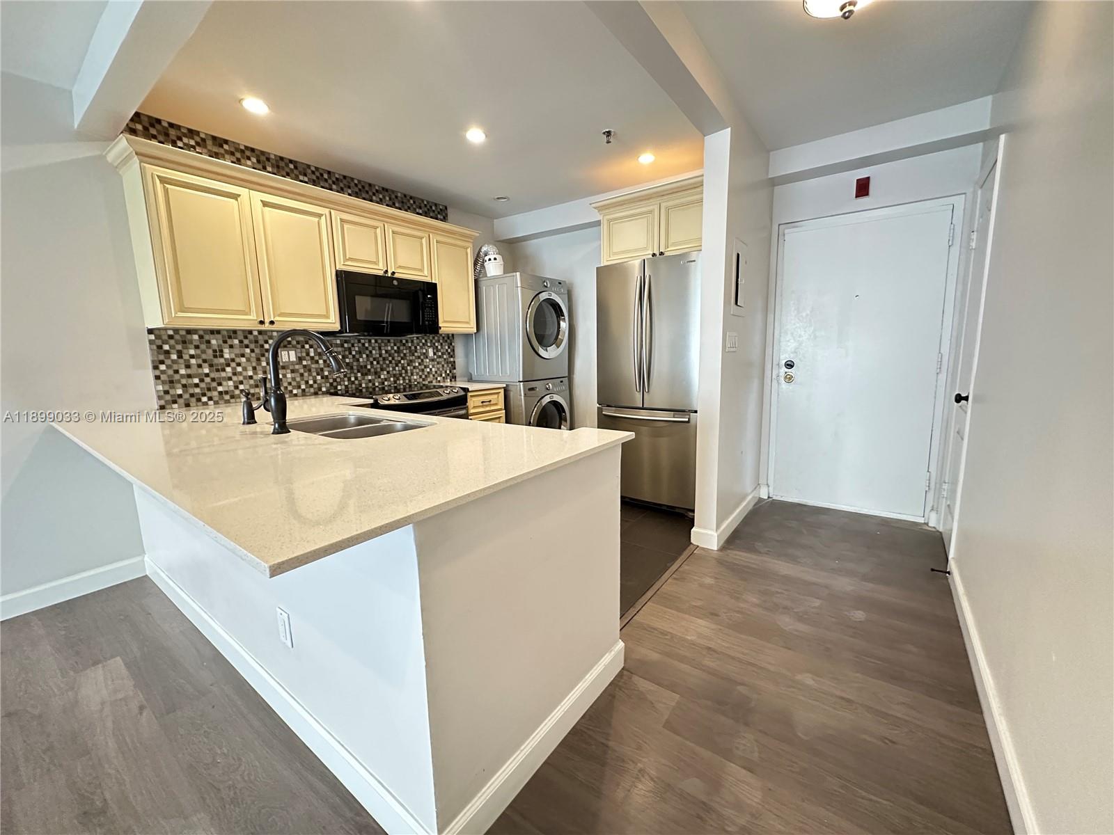 677 Northeast 24th Street, Unit 406 Miami, FL 33137 - Photo 4 of 15 a bathroom with a sink a mirror and a shower