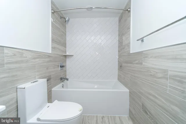 a bathroom with a sink mirror bathtub and toilet