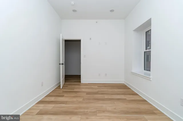 an empty room with wooden floor
