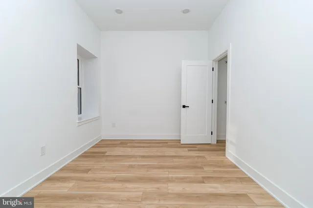 a view of room with window and hardwood floor