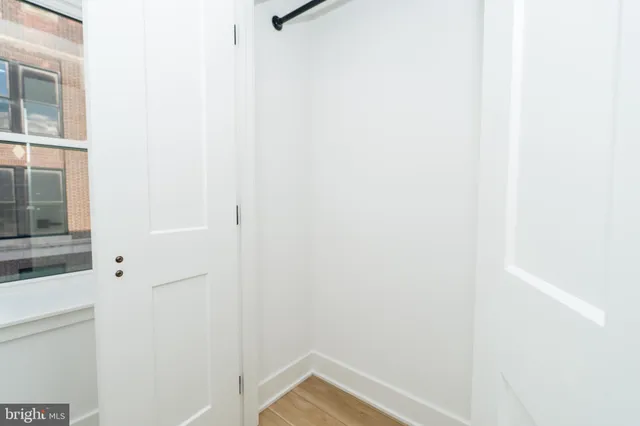 a view of a room with a cabinet and chandelier