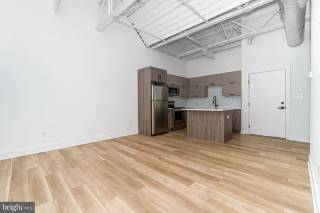 a view of a room with wooden floor