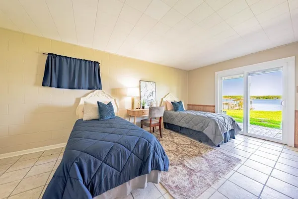 a bedroom with double bed and a window