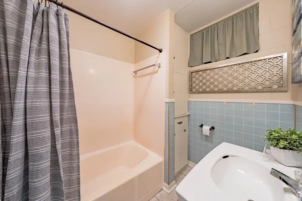 a bathroom with a bathtub and shower