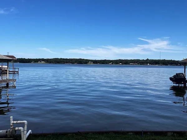 a view of a lake with houses in back