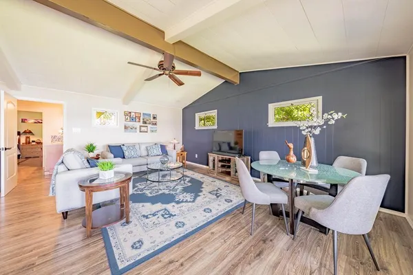 a living room with furniture and wooden floor