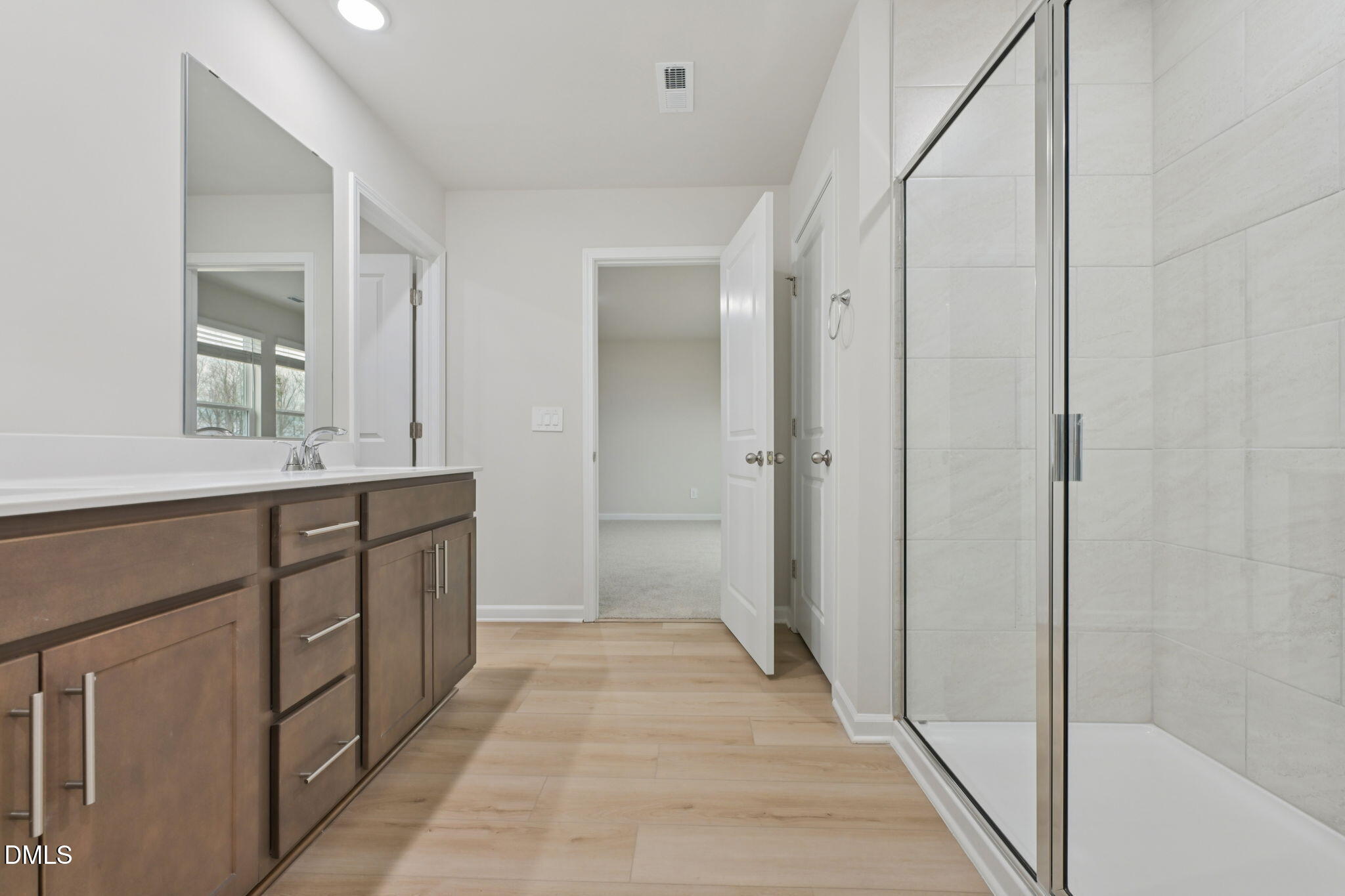 2147 Topsail Road Durham, NC 27703 - Photo 20 of 31 a bathroom with a double vanity sink and a mirror