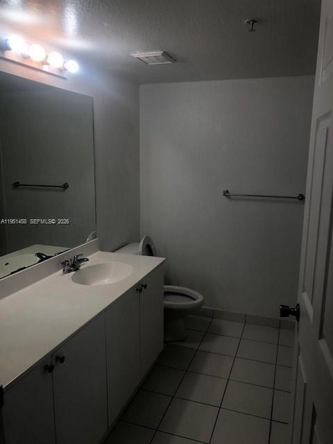 15430 Southwest 284th Street, Unit 6307 Homestead, FL 33033 - Photo 11 of 17 a bathroom with a sink a toilet and a mirror
