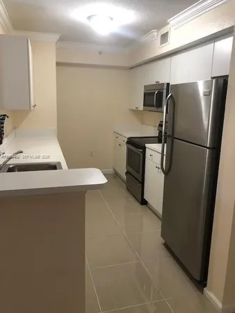 a kitchen with a refrigerator sink stove and cabinets