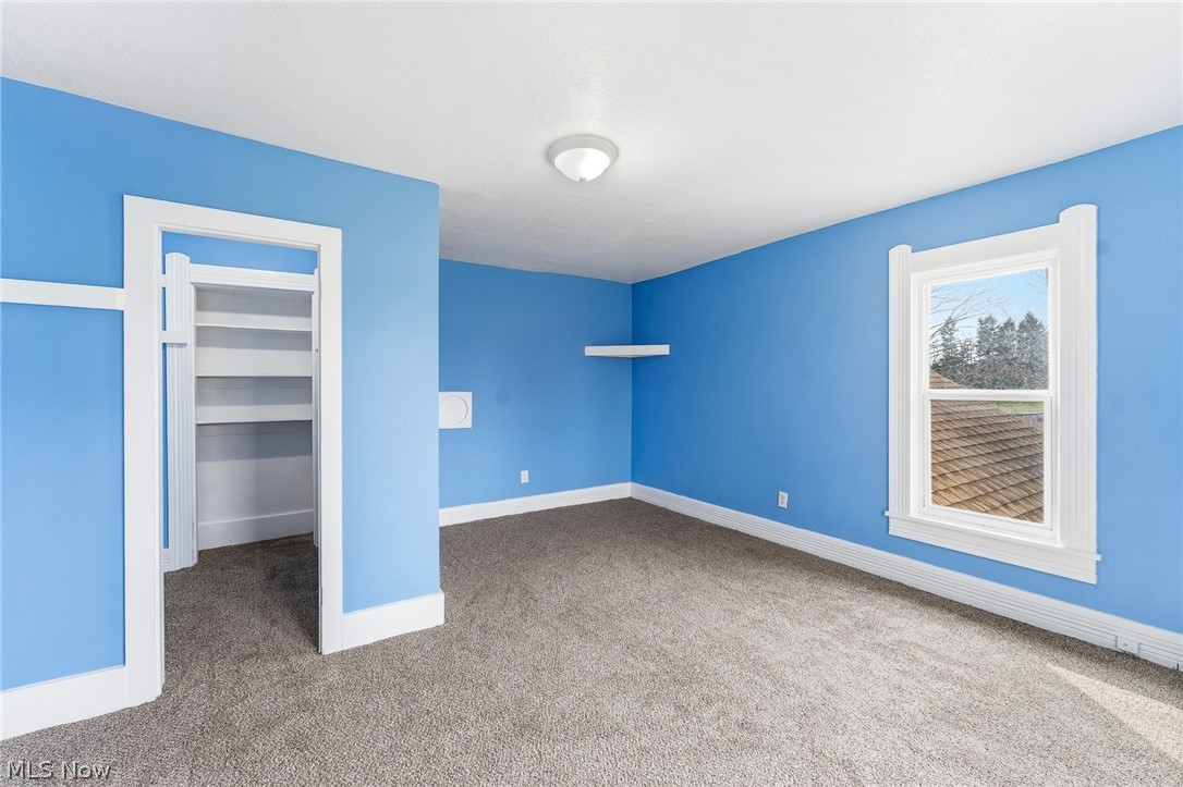 563 Geneva Avenue Struthers, OH 44471 - Photo 15 of 31 Unfurnished bedroom with a spacious closet and light colored carpet