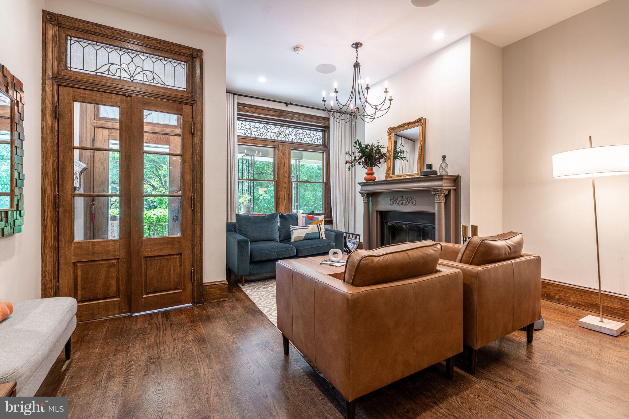 239 South 46th Street Philadelphia, PA 19139 - Photo 1 of 34 a living room with furniture a ceiling fan a fireplace and a window