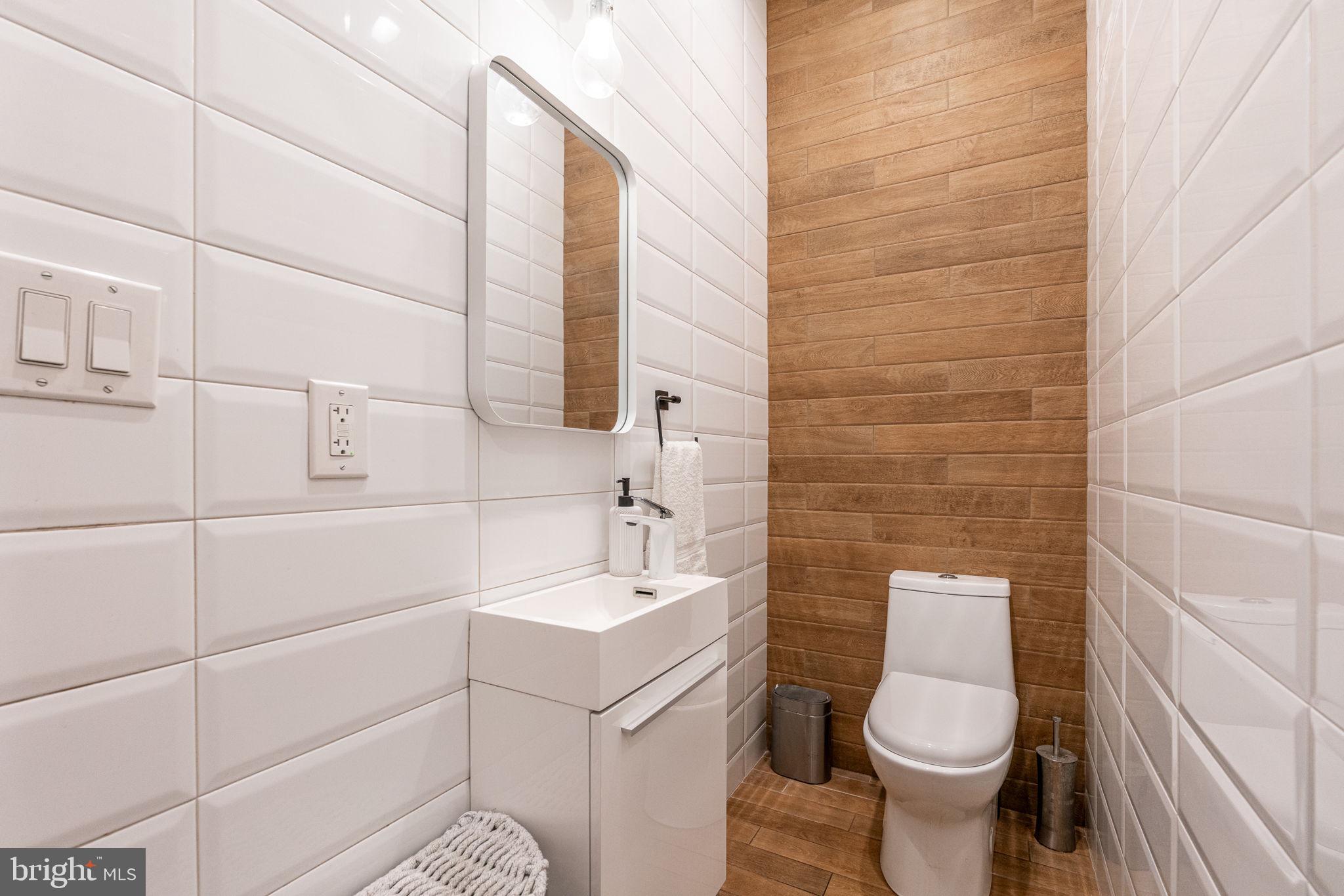 239 South 46th Street Philadelphia, PA 19139 - Photo 11 of 34 a bathroom with a sink a toilet and mirror