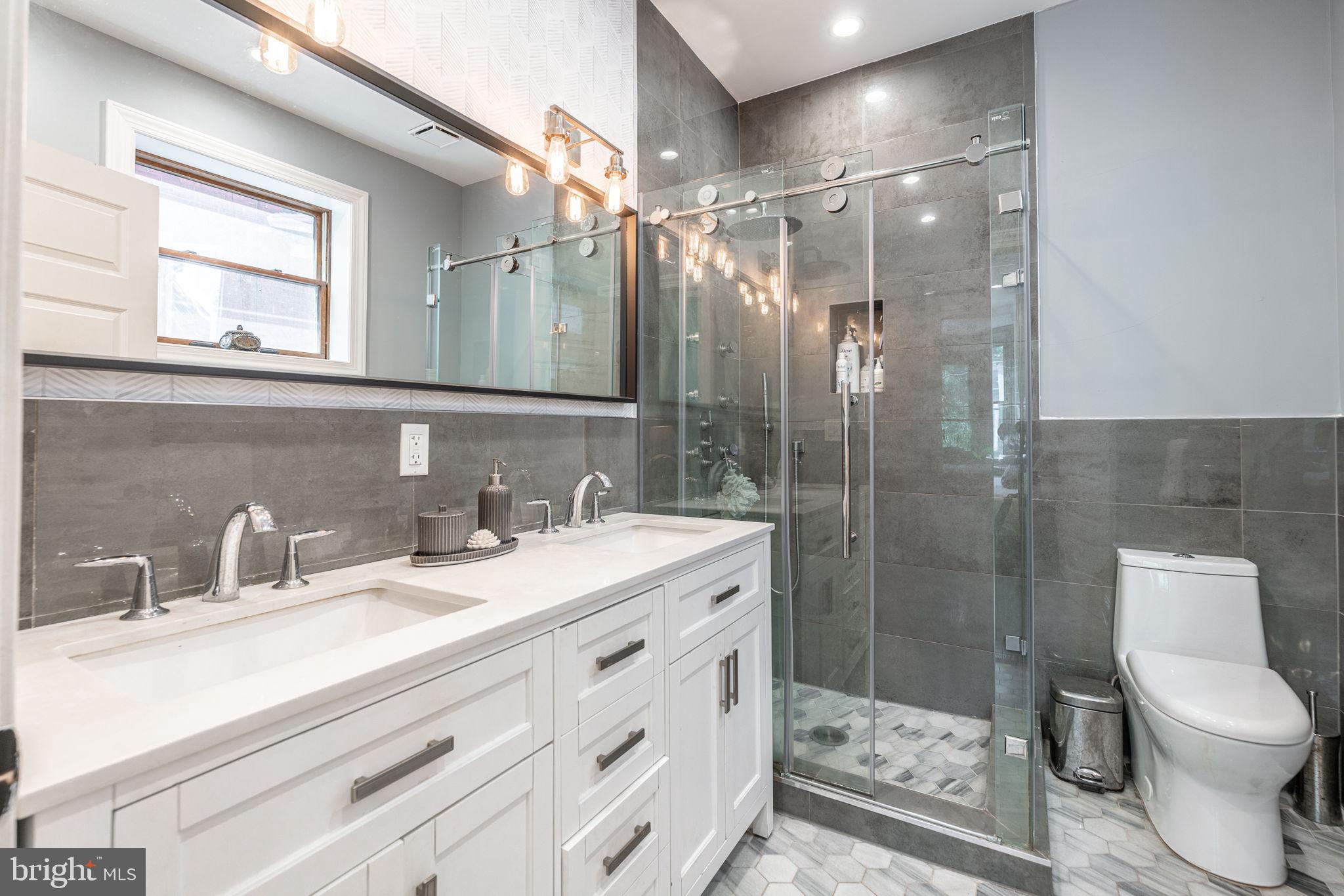 239 South 46th Street Philadelphia, PA 19139 - Photo 17 of 34 a bathroom with a double vanity sink toilet and shower