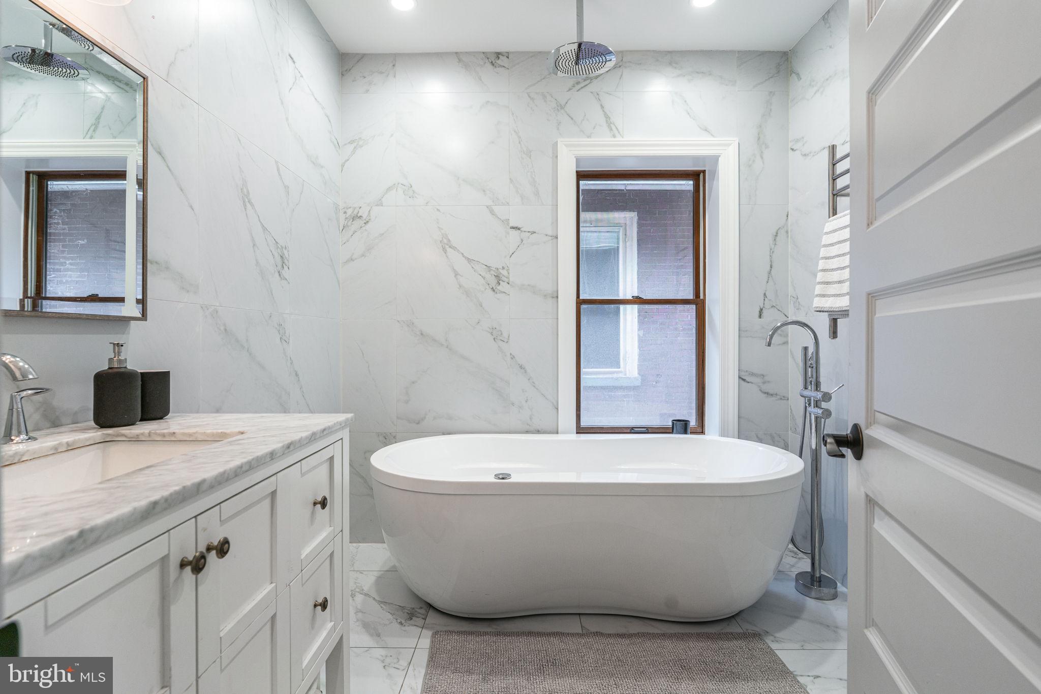239 South 46th Street Philadelphia, PA 19139 - Photo 24 of 34 a white bath tub sitting next to a white toilet