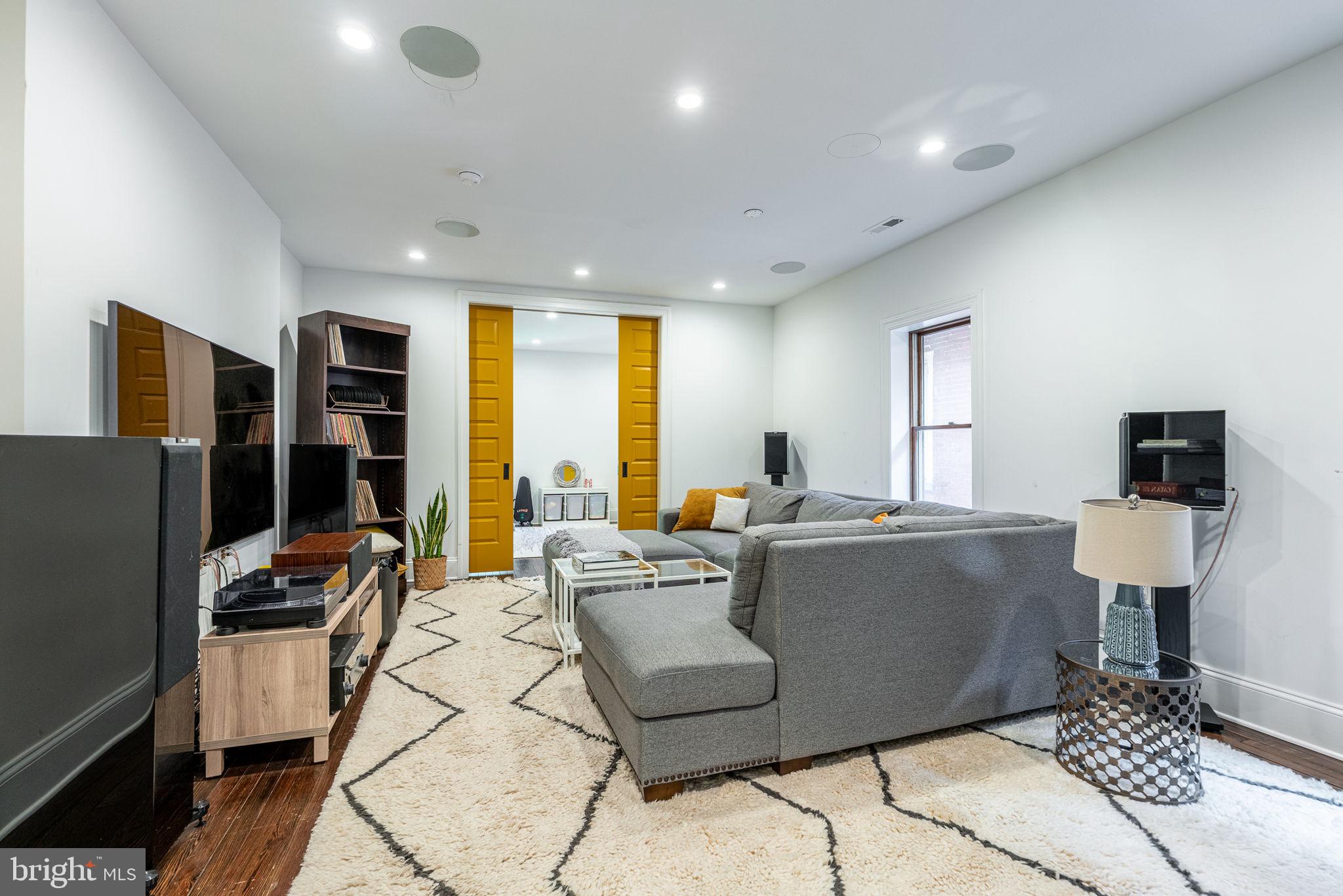 239 South 46th Street Philadelphia, PA 19139 - Photo 27 of 34 a living room with fireplace furniture and a flat screen tv