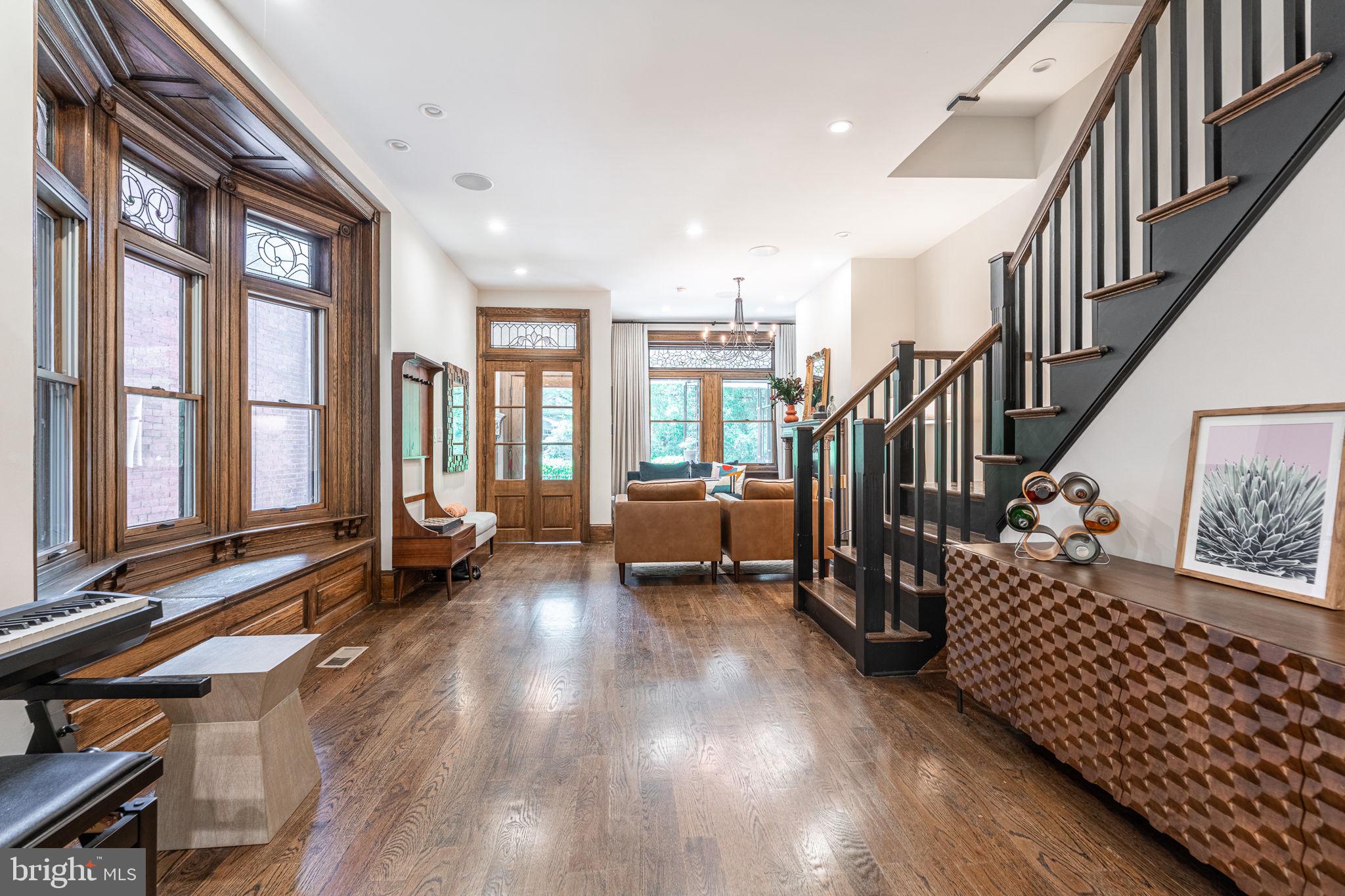 239 South 46th Street Philadelphia, PA 19139 - Photo 4 of 34 a view of front door with dining room and wooden floor