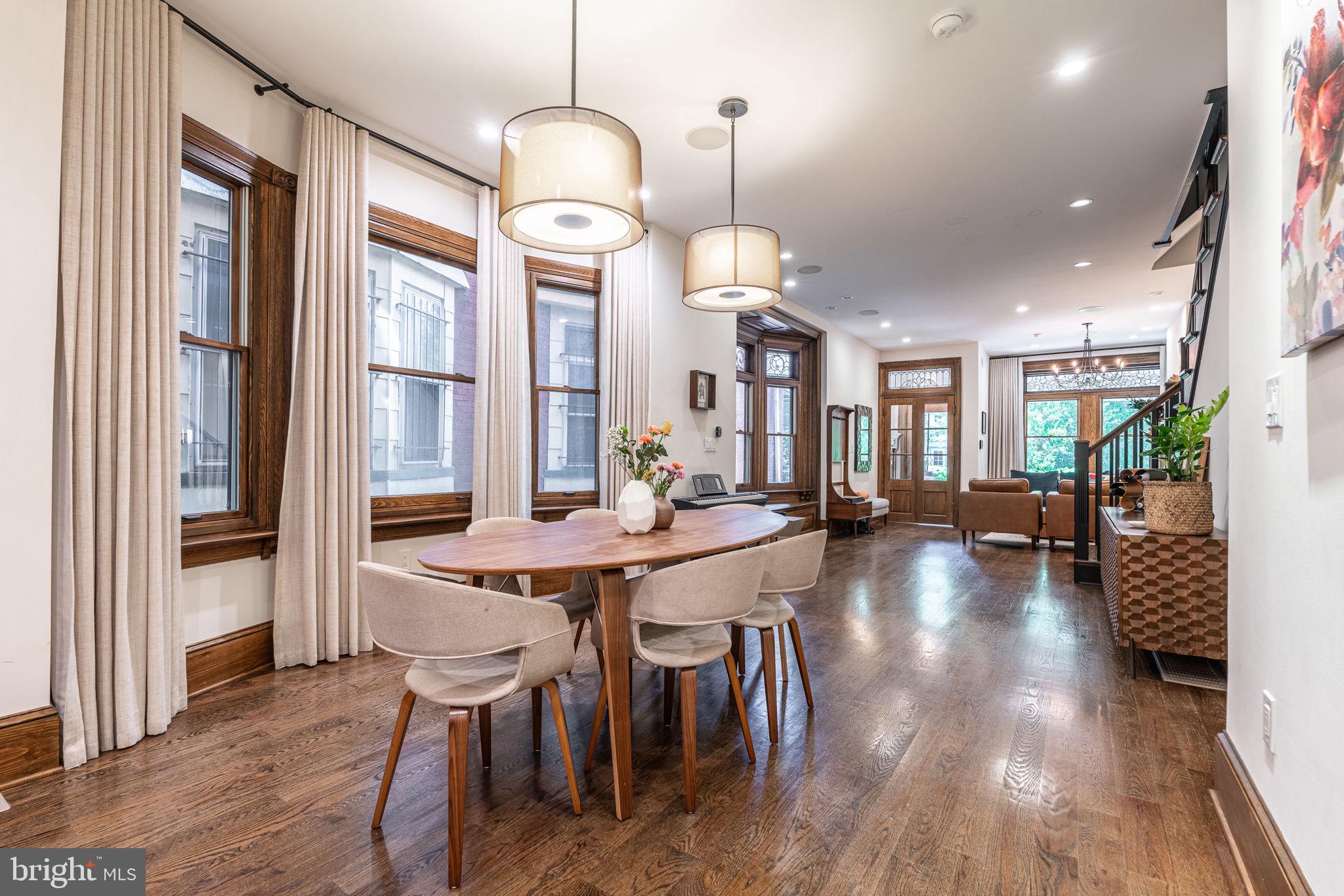 239 South 46th Street Philadelphia, PA 19139 - Photo 6 of 34 a view of a dining room and livingroom with furniture wooden floor a chandelier