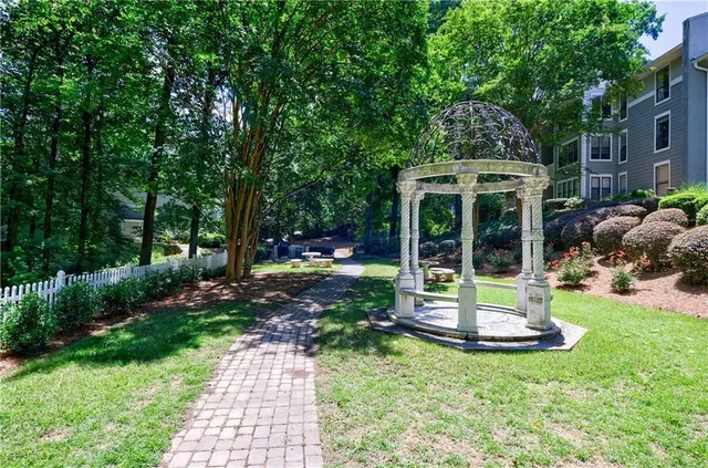 a view of a house with backyard garden and sitting area